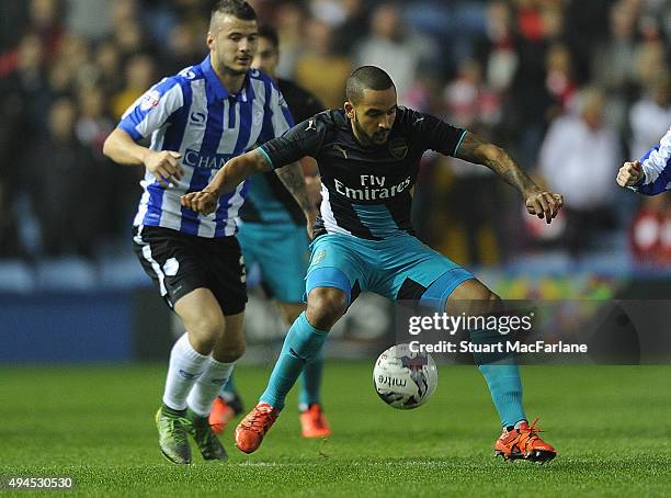 Theo Walcott of Arsenal challenged by Daniel Pudil of Sheffield Wednesday during the Capital One Cup Fourth Round match between Sheffield Wednesday...