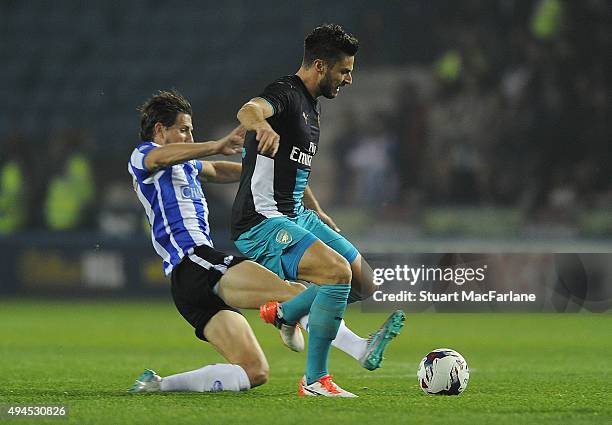 Olivier Giroud of Arsenal challenged by Sam Hutchinson of Sheffield Wednesday during the Capital One Cup Fourth Round match between Sheffield...