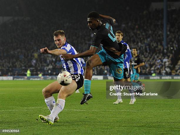 Alex Iwobi of Arsenal challenged by Tom Lees of Sheffield Wednesday during the Capital One Cup Fourth Round match between Sheffield Wednesday and...