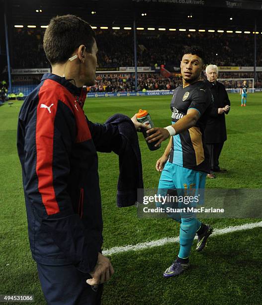 Arsenal doctor Gary O'Driscoll hands a drink to Alex Oxlade-Chamberlain before the Capital One Cup Fourth Round match between Sheffield Wednesday and...