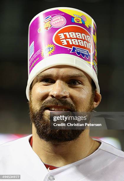 Starting pitcher Josh Collmenter of the Arizona Diamondbacks has bubble gum dumped over his head after defeating the Cincinnati Reds 4-0 in the MLB...
