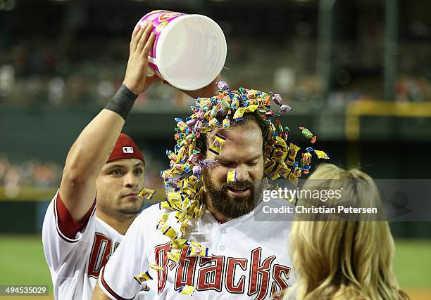 Starting pitcher Josh Collmenter of the Arizona Diamondbacks has bubble gum dumped over his head by Gerardo Parra after defeating the Cincinnati Reds...