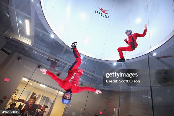 Flying instructors Derek Vanboeschoter and David Schnaible demonstrate wind tunnel flying at the iFly indoor skydiving facility on May 29, 2014 in...