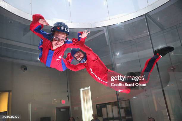 Flying instructor David Schnaible teaches wind tunnel flying to nine-year-old Liam Harrison at the iFly indoor skydiving facility on May 29, 2014 in...