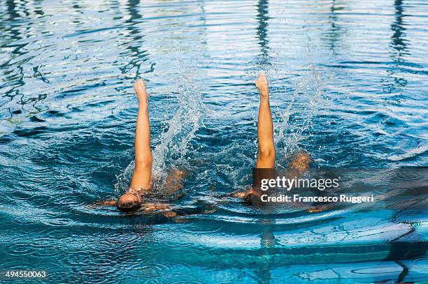 two girls synchro swimming - synchronized swimming stock pictures, royalty-free photos & images