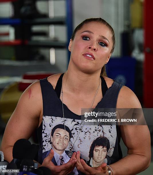 Mixed Martial Arts fighter Ronda Rousey, wearing a shirt with portraits of former heavyweight boxing champion Muhammad Ali and the late US singer...