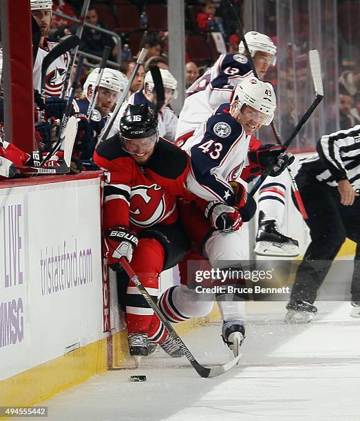 Scott Hartnell of the Columbus Blue Jackets squeezes Jacob Josefson of the New Jersey Devils into the boards during the second period at the...