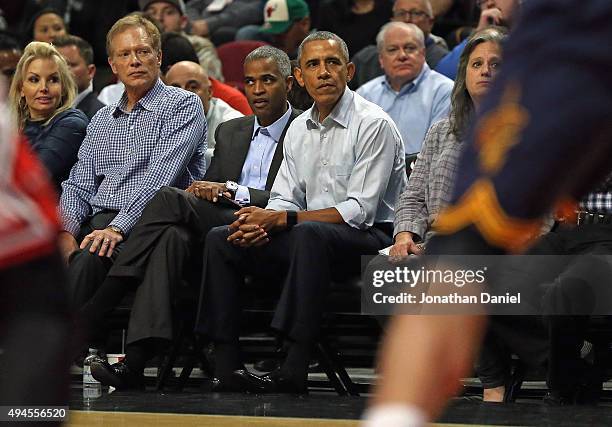President Barack Obama sits courtside as the Chicago Bulls take on the Cleveland Cavaliers during the season opening game at the United Center on...