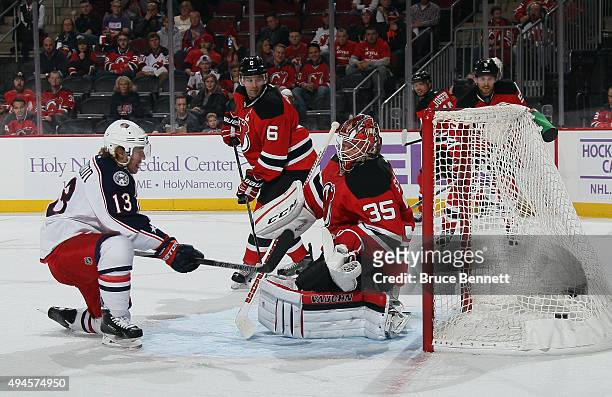 Cam Atkinson of the Columbus Blue Jackets scores at 9:38 of the third period against Cory Schneider of the New Jersey Devils at the Prudential Center...