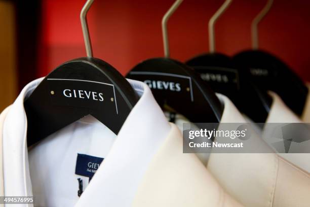 Close-up picture of white mens dinner jackets in the flagship Gieves & Hawkes store on Savile Row.