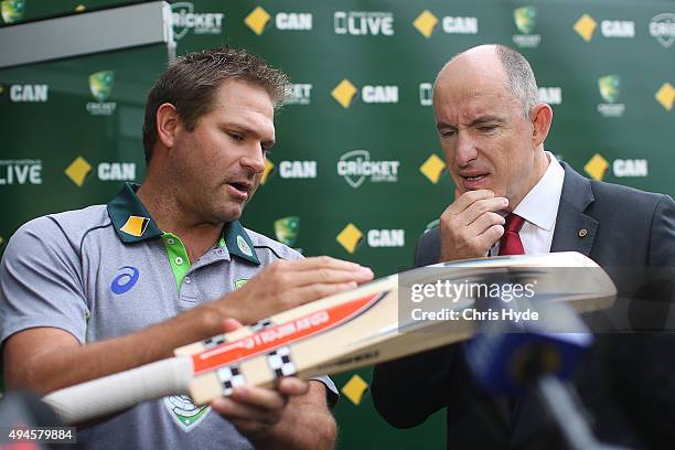 Former Australian player Ryan Harris and Stuart Robert MP talk during the Cricket Australia Centenary of ANZACs Test announcement at The Gabba on...