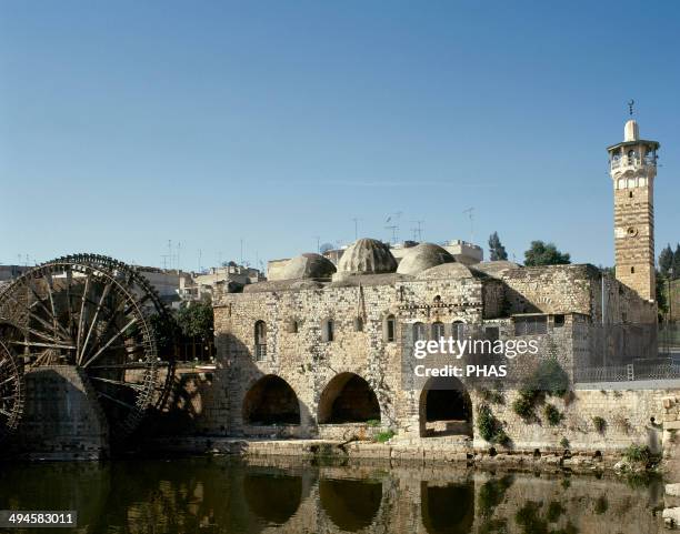 Syria. Hama. An-Nuri Mosque, built by Nur Al-Din. 12th century. On the left, medieval noria near the Orontes river.