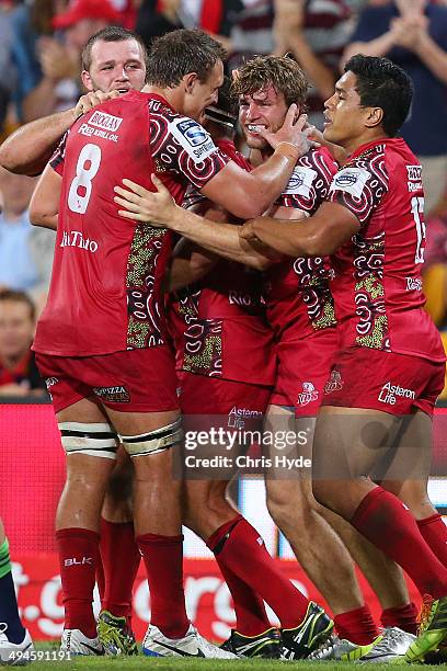 Dom Shipperley of the Reds celebrates with team mates after scoring a try during the round 16 Super Rugby match between the Reds and the Highlanders...