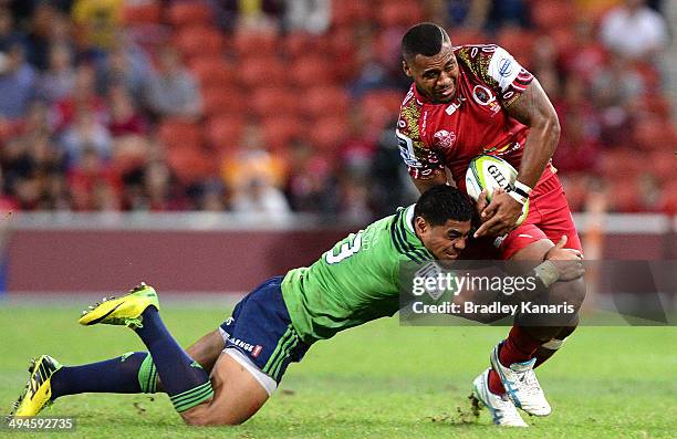 Samu Kerevi of the Reds is tackled by Malakai Fekitoa of the Highlanders during the round 16 Super Rugby match between the Reds and the Highlanders...