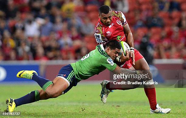 Samu Kerevi of the Reds is tackled by Malakai Fekitoa of the Highlanders during the round 16 Super Rugby match between the Reds and the Highlanders...