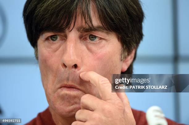 Germany's football head coach Joachim Loew gestures as he answers journalists' questions during a press conference of the German national football...