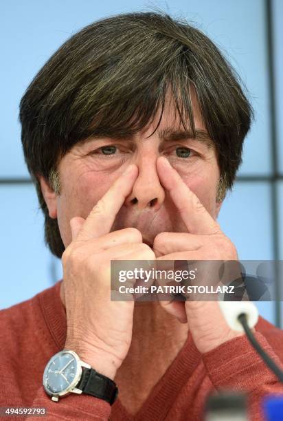 Germany's football head coach Joachim Loew gestures as he answers journalists' questions during a press conference of the German national football...