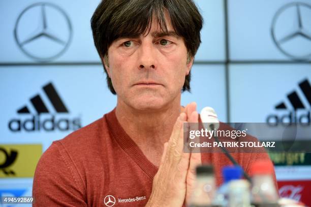 Germany's football head coach Joachim Loew gestures as he answers journalists' questions during a press conference of the German national football...