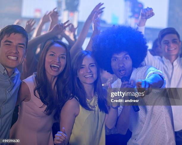 happy group of friends partying at a karaoke bar - vip bar stock pictures, royalty-free photos & images