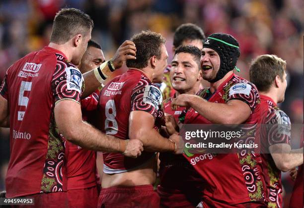 Jake Schatz of the Reds celebrates with team mates after scoring the match winning try after the full time siren after the round 16 Super Rugby match...