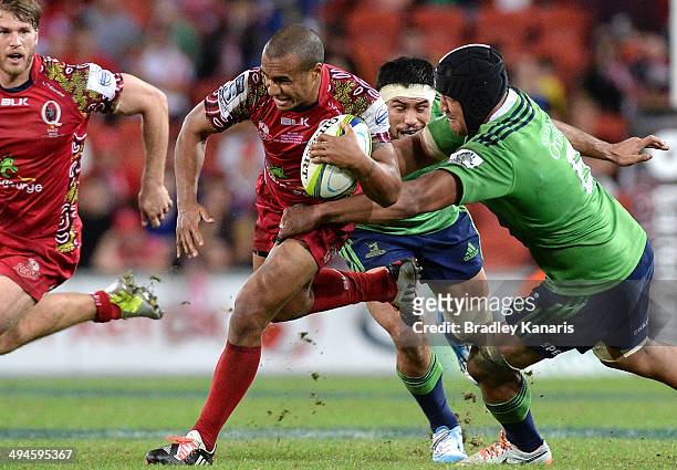 Will Genia of the Reds attempts to break free from the defence during the round 16 Super Rugby match between the Reds and the Highlanders at Suncorp...