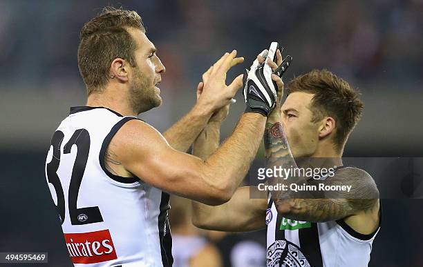 Travis Cloke of the Magpies is congratulated by Alex Fasolo after kicking a goal during the round 11 AFL match between the St Kilda Saints and the...