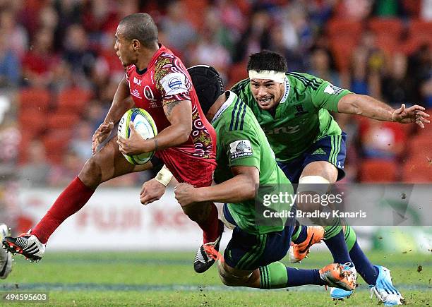 Will Genia of the Reds attempts to break free from the defence during the round 16 Super Rugby match between the Reds and the Highlanders at Suncorp...