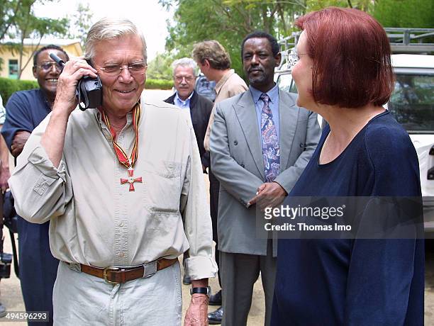 Karlheinz Boehm, German Actor and Founder of 'People for People' organisation for development aid, talks to his wife Almaz on mobil phone after...