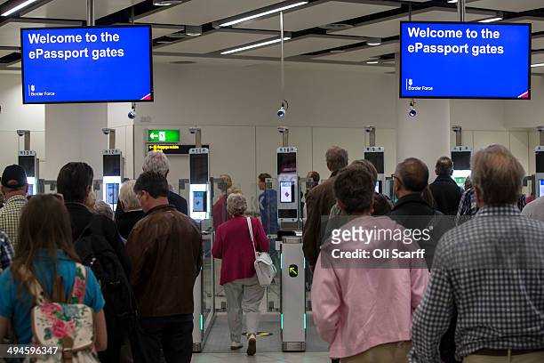 Passengers arriving at Gatwick Airport use the 'ePassport gates' at Passport Control on the UK Border on May 28, 2014 in London, England. Border...
