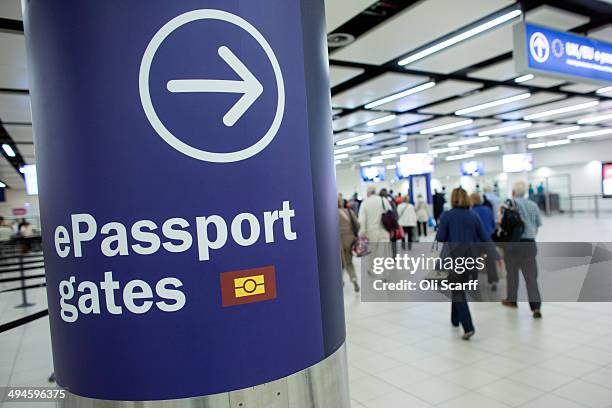 Passengers arriving at Gatwick Airport use the 'ePassport gates' at Passport Control on the UK Border on May 28, 2014 in London, England. Border...