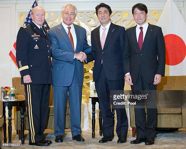 Defense Secretary Chuck Hagel poses with Japanese Prime Minister Shinzo Abe , Japanese Defense Minister Itsunori Onodera and Gen. Martin Dempsey,...