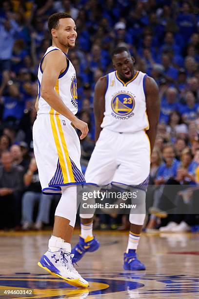 Stephen Curry and Draymond Green of the Golden State Warriors react after a three point basket by Green against the New Orleans Pelicans during the...