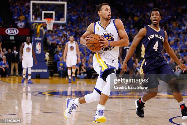 Stephen Curry of the Golden State Warriors drives to the hoop against Ish Smith of the New Orleans Pelicans during the NBA season opener at ORACLE...
