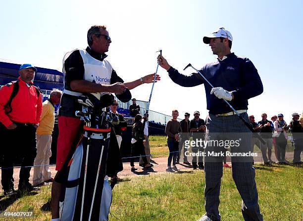Bradley Dredge of Wales changes his lob wedge for a putter at the 16th green during the Nordea Masters at the PGA Sweden National on May 30, 2014 in...
