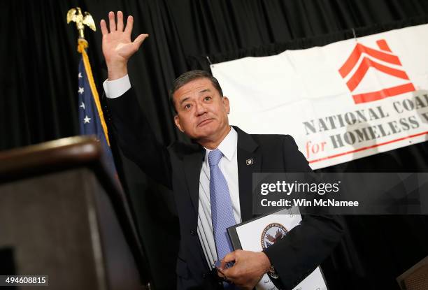 Secretary of Veterans Affairs Eric Shinseki waves goodbye after addressing the National Coalition for Homeless Veterans May 30, 2014 in Washington,...