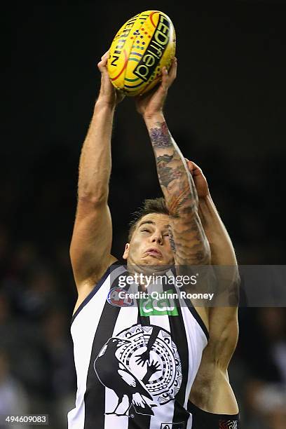 Jamie Elliott of the Magpies marks infront of Sean Dempster of the Saints during the round 11 AFL match between the St Kilda Saints and the...