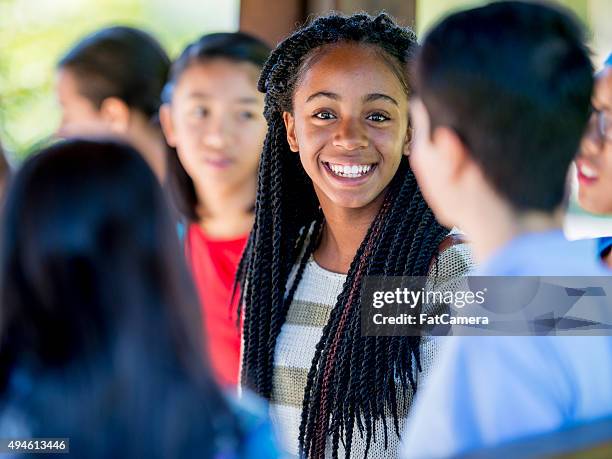 teenage friends talking between class - high school building exterior stock pictures, royalty-free photos & images