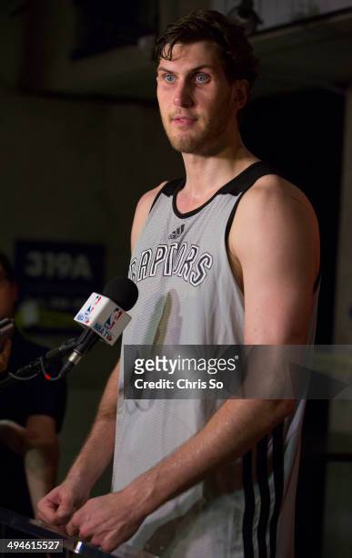 Toronto, ON - MAY 29, 2014 - Toronto Raptor prospect Jordan Bachynski 7'2" stature towers over members of the media during a press conference at the...