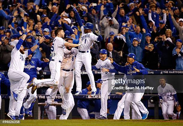 Eric Hosmer, Mike Moustakas and Jarrod Dyson of the Kansas City Royals celebrate the Royals 5-4 in 14 innings against the New York Mets during Game...