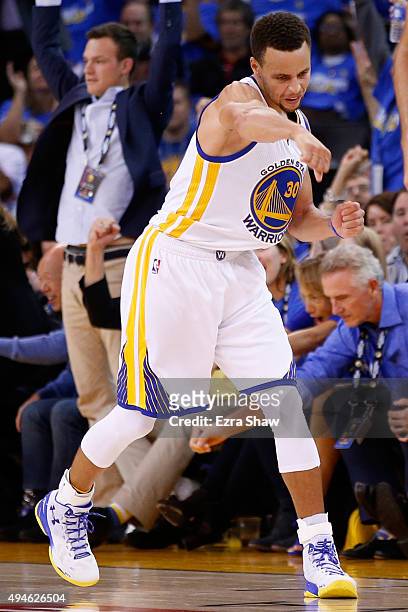 Stephen Curry of the Golden State Warriors celebrates after a three point basket against the New Orleans Pelicans during the NBA season opener at...