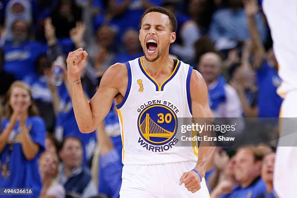 Stephen Curry of the Golden State Warriors celebrates after a three point basket against the New Orleans Pelicans during the NBA season opener at...