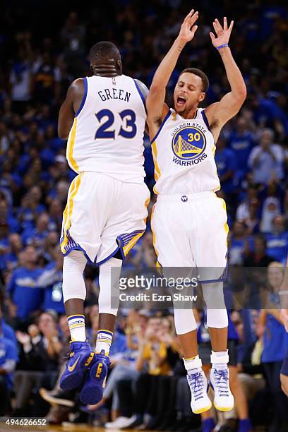 Stephen Curry of the Golden State Warriors celebrates with Draymond Green after a three point basket against the New Orleans Pelicans during the NBA...