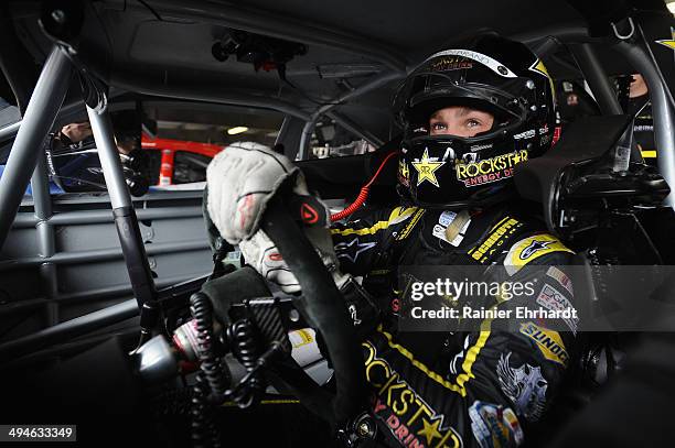 Dylan Kwasniewski, driver of the Rockstar Chevrolet, sits in his car during practice for the NASCAR Nationwide Series Buckle Up 200 Presented by...