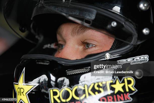 Dylan Kwasniewski, driver of the Rockstar Chevrolet, sits in his car in the garage area during practice for the NASCAR Nationwide Series Buckle Up...