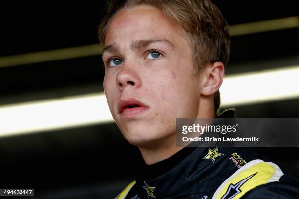 Dylan Kwasniewski, driver of the Rockstar Chevrolet, looks on in the garage area during practice for the NASCAR Nationwide Series Buckle Up 200...