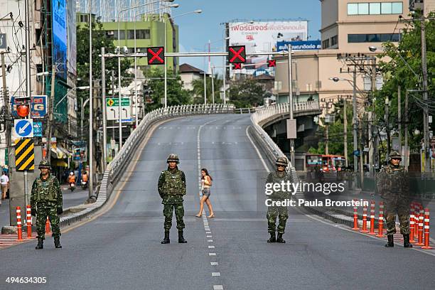 Local pedestrian crosses as Thai police take over the streets surrounding the Victory Monument on May 30, 2014 in Bangkok, Thailand. Thai military...