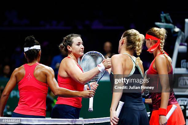 Raquel Kops-Jones and Abigail Spears of the USA congratulate Timea Babos of Hungary and Kristina Mladenovic of France for defeating them in a doubles...