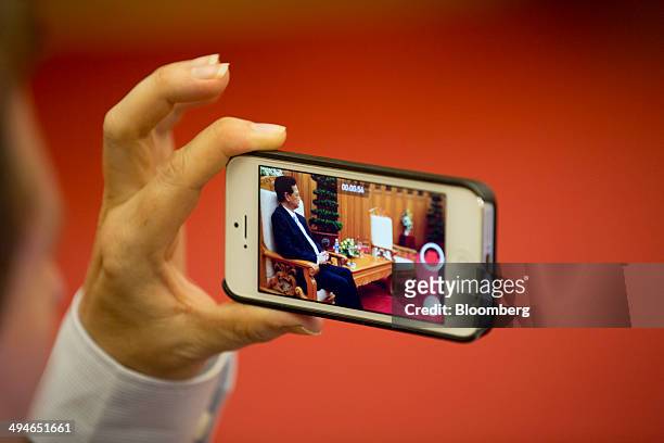 Nguyen Tan Dung, Vietnam's prime minister, is seen on a Apple Inc. IPhone 4s smartphone during an interview in Hanoi, Vietnam, on Friday, May 30,...