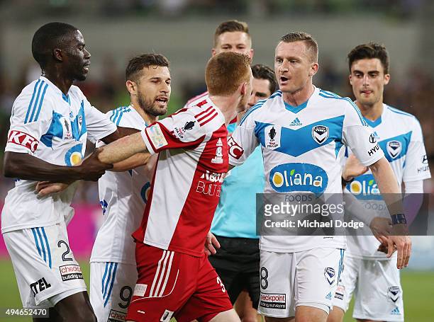Jason Geria of the Victory holds back Nick Hegarty of the City who is confronted by Besart Berisha of the Victory after a contest during the FFA Cup...