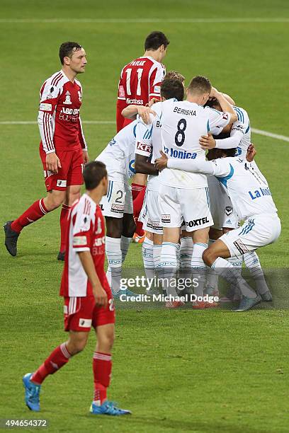 Victory players huddle around Jason Geria after he kicked a goal during the FFA Cup Semi Final match between Hume City and Melbourne Victory at AAMI...